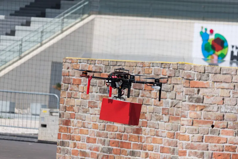 Drone carrying a brick